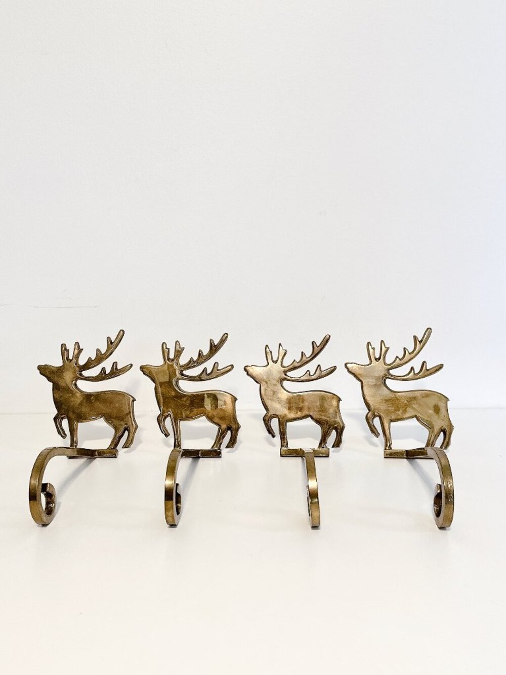 SET OF FOUR BRASS REINDEER MANTEL STOCKING HANGERS